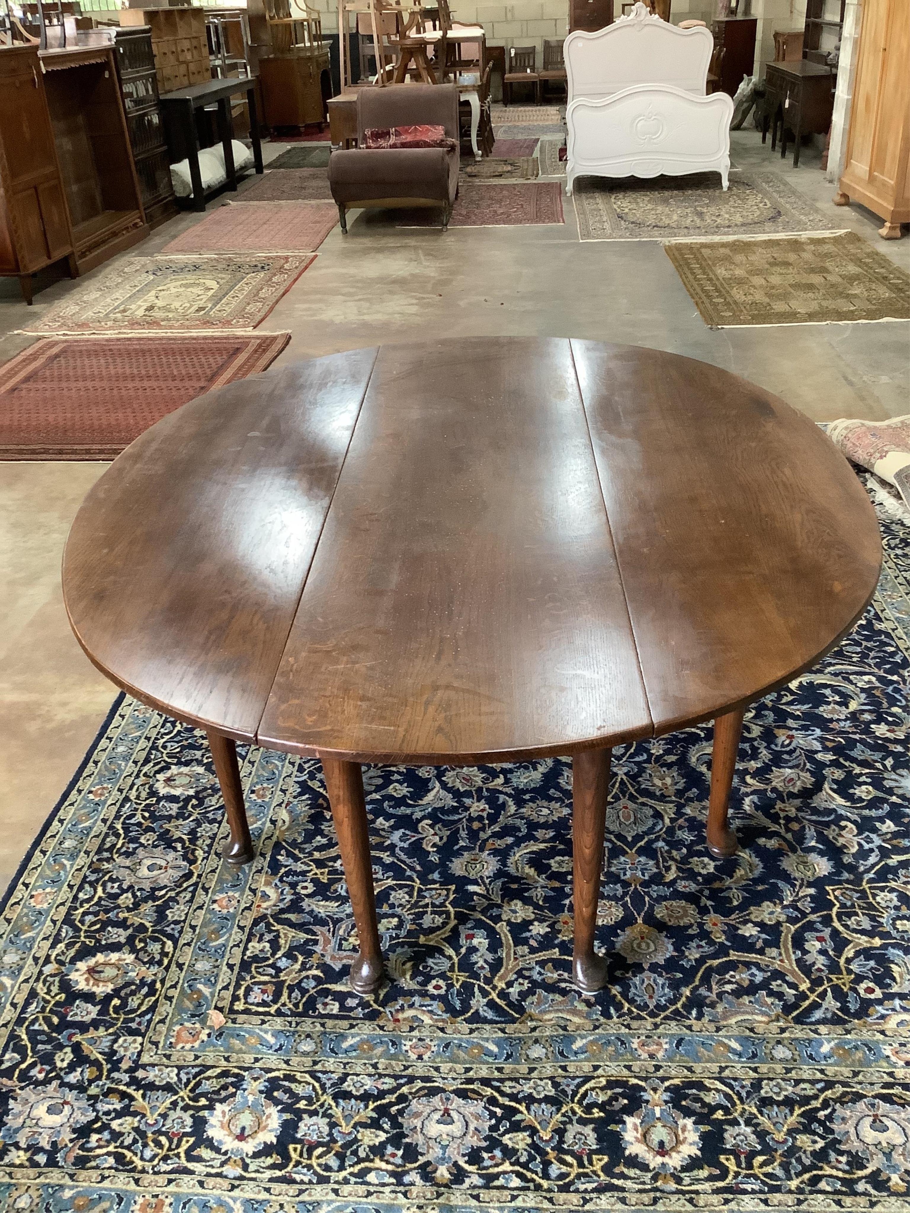 A reproduction 18th century style oak drop leaf wake table, length 194cm, width 150cm extended, height 77cm